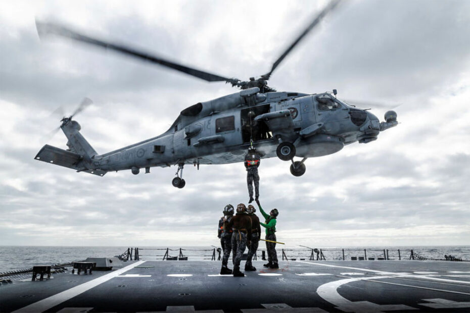 El teniente Hudson Wakefield es izado por el helicóptero MH-60R 'Phoenix' embarcado en el HMAS Sydney durante los ejercicios de izado mientras el buque se encuentra desplegado en un despliegue de presencia regional. ©Defensa de Australia